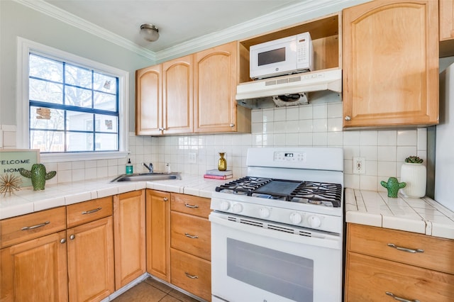 kitchen with sink, crown molding, white appliances, tile counters, and decorative backsplash