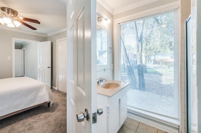 bathroom featuring tile patterned flooring, vanity, ornamental molding, and ceiling fan