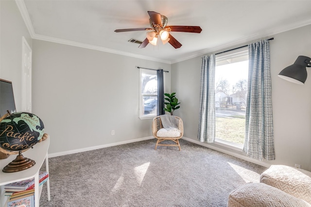 sitting room with ornamental molding, ceiling fan, and carpet flooring