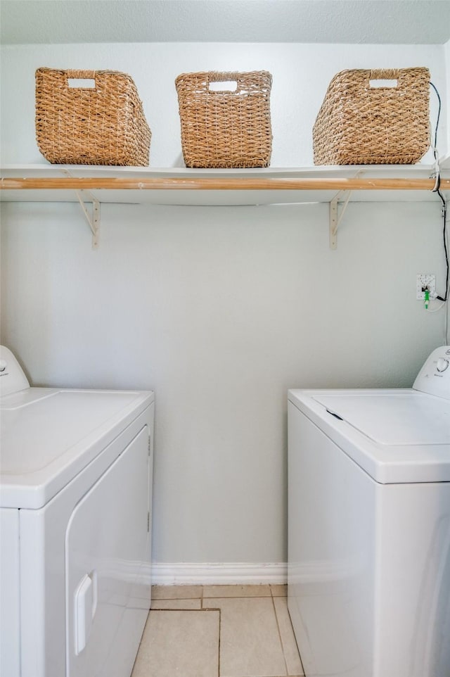 clothes washing area with independent washer and dryer and tile patterned floors