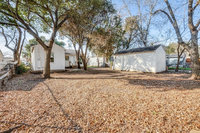 back of house featuring a storage shed