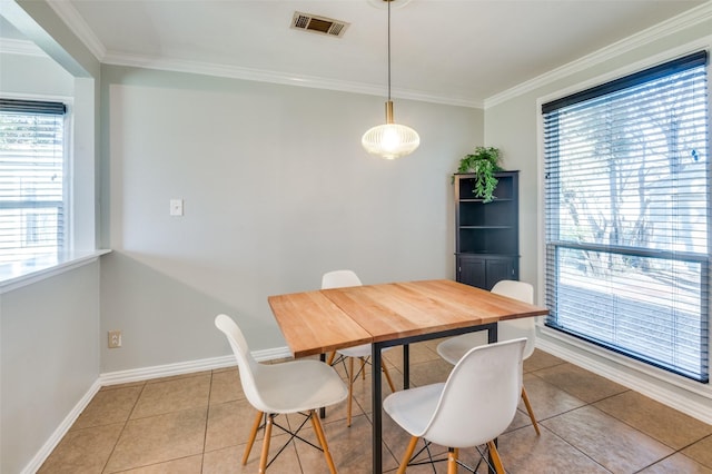 tiled dining area featuring crown molding