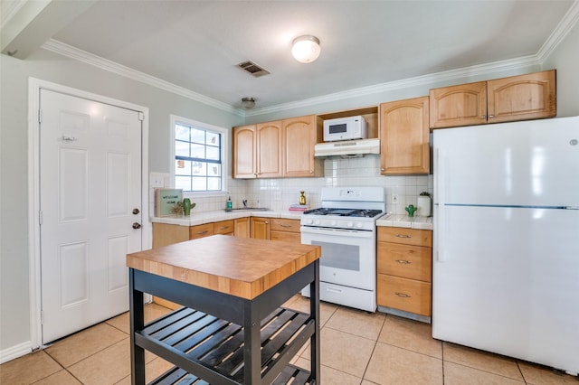 kitchen featuring crown molding, light tile patterned floors, white appliances, and backsplash