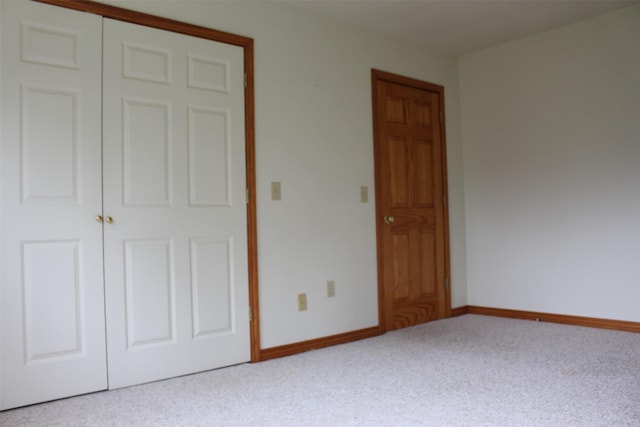 unfurnished bedroom with a closet and carpet flooring