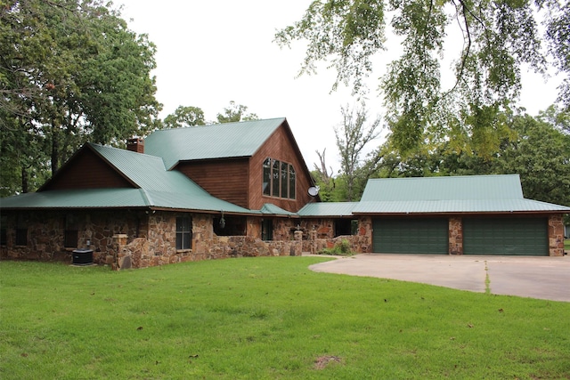 view of front of property featuring a garage, central AC unit, and a front yard