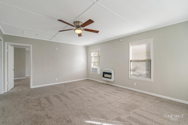 empty room with heating unit, light carpet, and ceiling fan