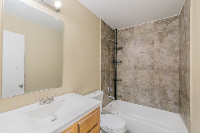 full bathroom featuring tiled shower / bath combo, vanity, and toilet