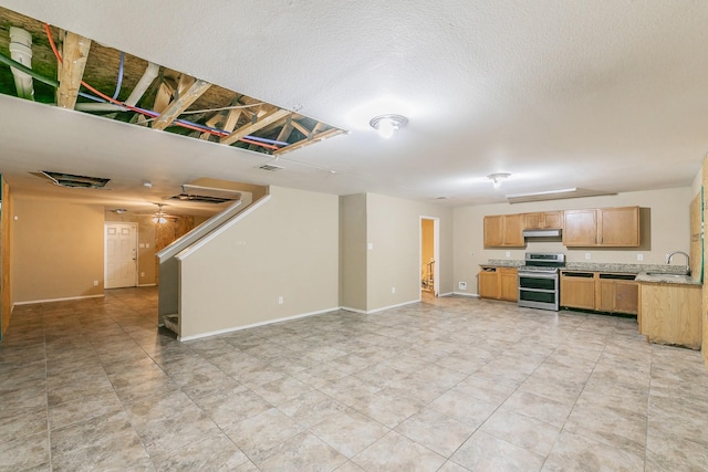 unfurnished living room featuring sink and a textured ceiling