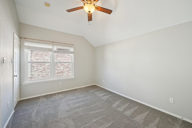 carpeted empty room featuring ceiling fan and lofted ceiling