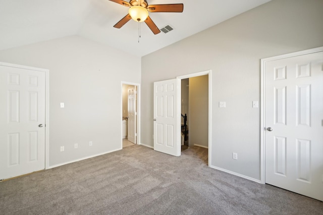 unfurnished bedroom with light carpet, vaulted ceiling, ceiling fan, and ensuite bathroom