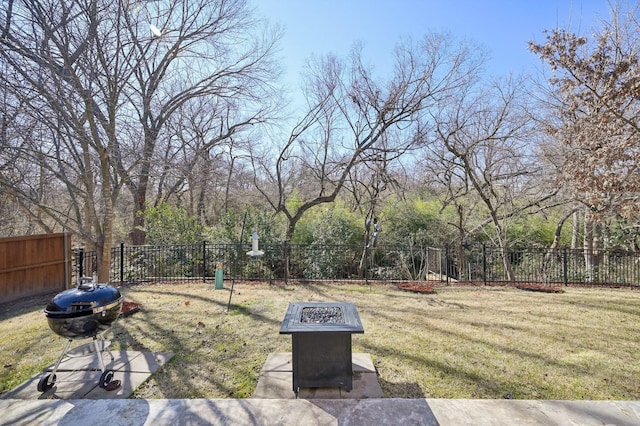 view of yard with an outdoor fire pit