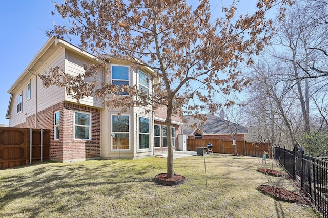 rear view of property with a yard and a patio