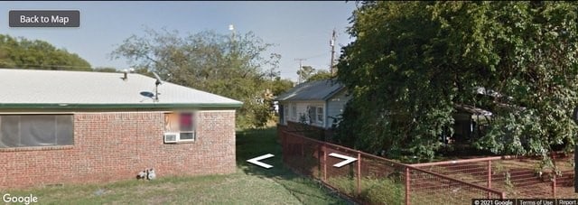 view of side of home featuring a lawn