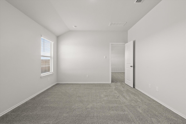 unfurnished room with lofted ceiling and carpet flooring