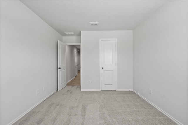 unfurnished bedroom with light colored carpet