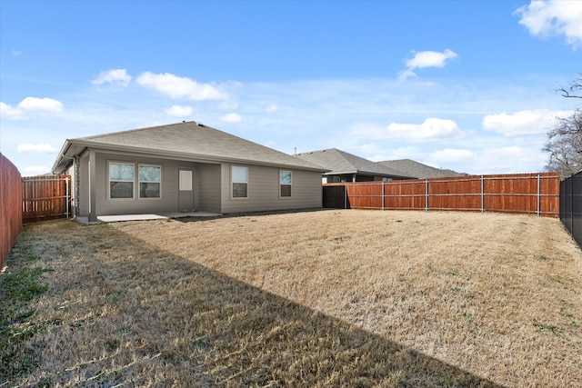 rear view of house with a lawn