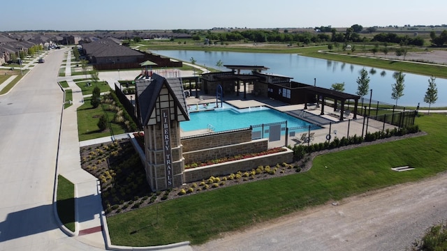 view of swimming pool featuring a water view and a patio area