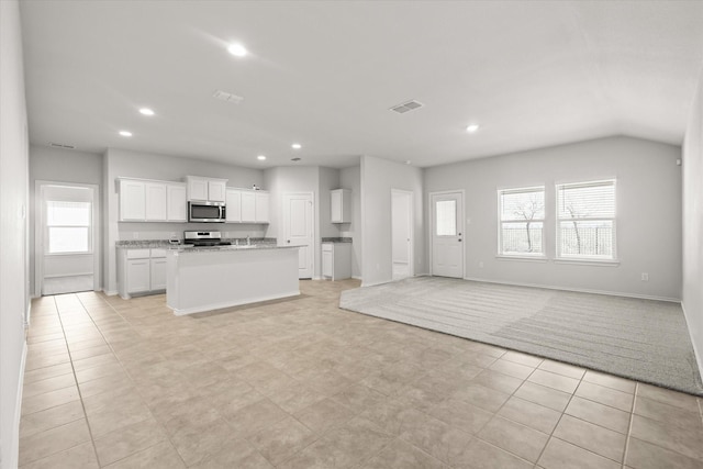 unfurnished living room featuring lofted ceiling