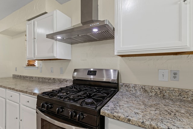 kitchen featuring white cabinetry, stainless steel range with gas cooktop, light stone countertops, and extractor fan