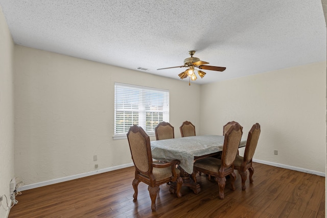 dining space featuring ceiling fan, dark hardwood / wood-style floors, and a textured ceiling