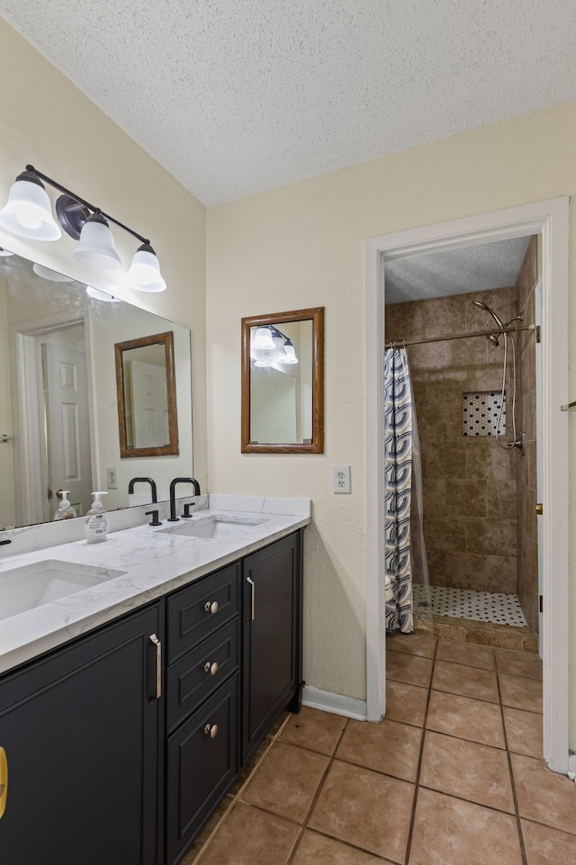 bathroom with vanity, tile patterned floors, a textured ceiling, and a shower with curtain