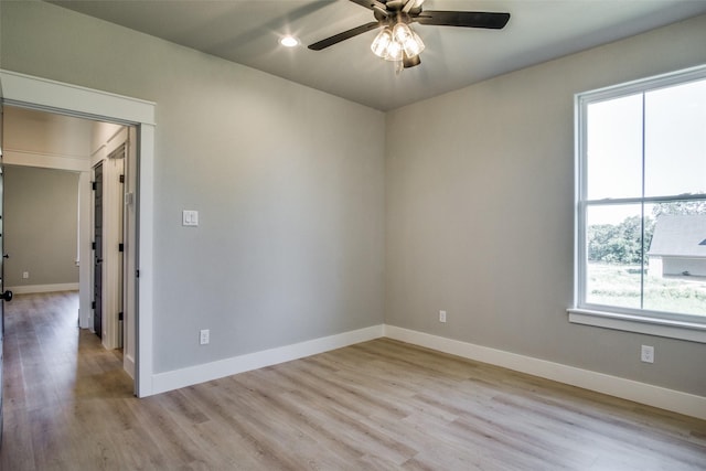 unfurnished room with ceiling fan and light hardwood / wood-style flooring