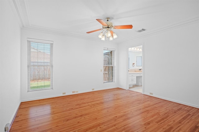 spare room with crown molding, ceiling fan, and light hardwood / wood-style flooring