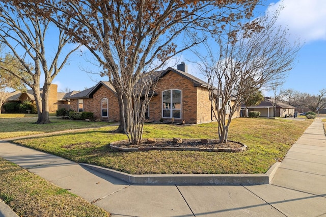 single story home featuring brick siding, a front lawn, and a chimney