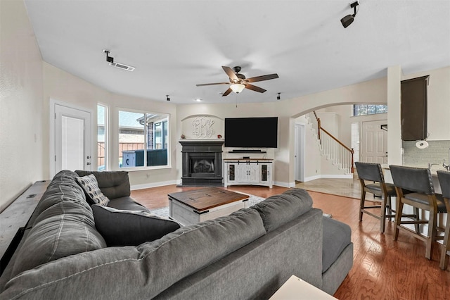 living room featuring ceiling fan and hardwood / wood-style floors