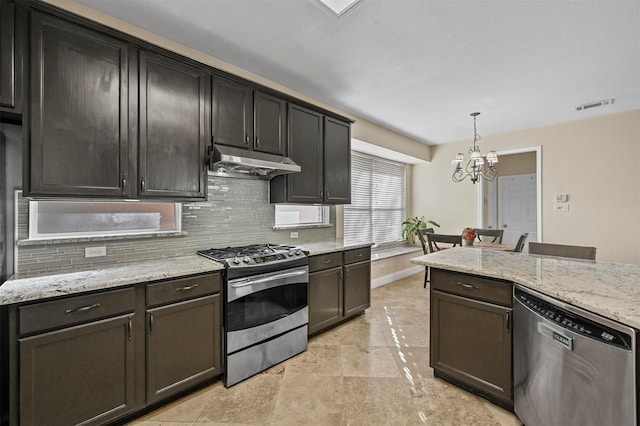 kitchen featuring decorative light fixtures, decorative backsplash, light stone counters, dark brown cabinetry, and stainless steel appliances