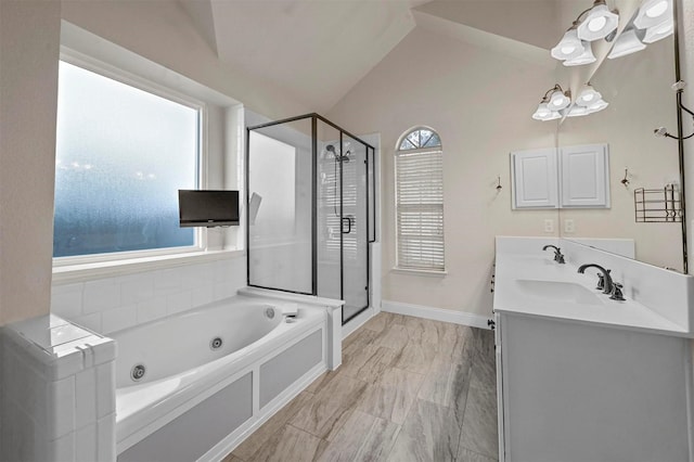 bathroom featuring shower with separate bathtub, vaulted ceiling, and vanity