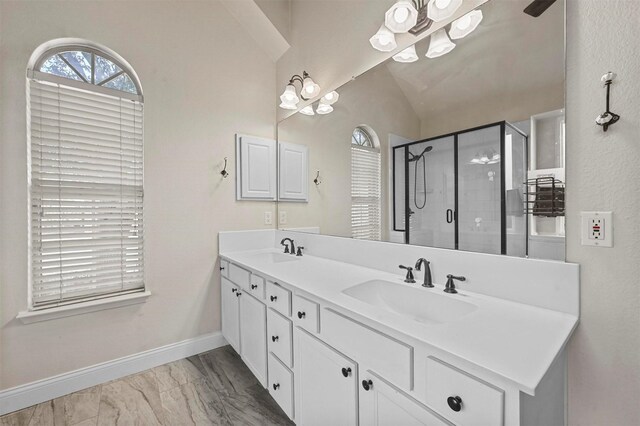 bathroom with vanity, independent shower and bath, and vaulted ceiling