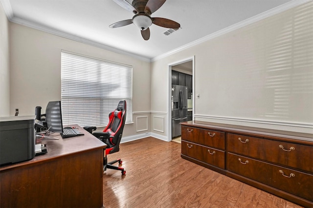 office space with crown molding, ceiling fan, and light hardwood / wood-style floors