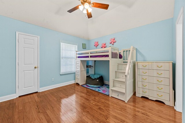 recreation room with an AC wall unit, dark wood-type flooring, lofted ceiling, and ceiling fan