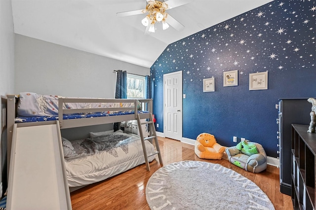 bedroom featuring ceiling fan, vaulted ceiling, and wood-type flooring