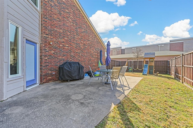 view of patio / terrace featuring a playground and area for grilling