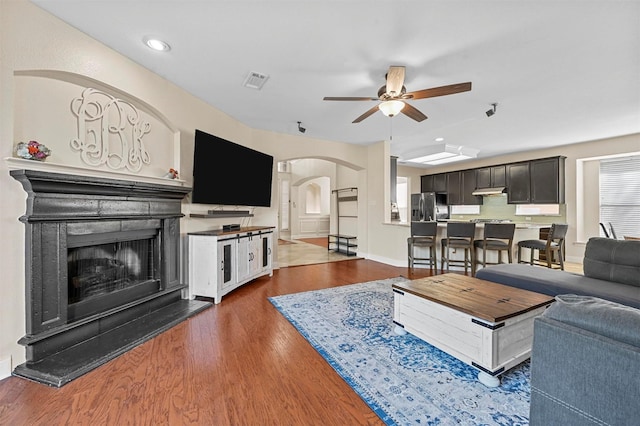 living room featuring dark hardwood / wood-style floors and ceiling fan