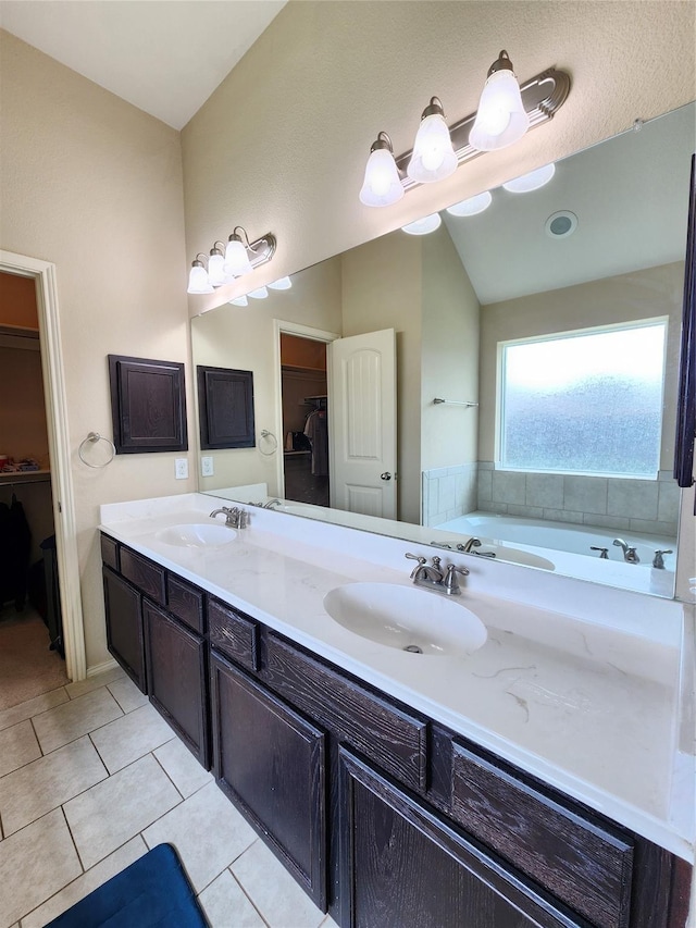 bathroom featuring vanity, vaulted ceiling, and tile patterned floors