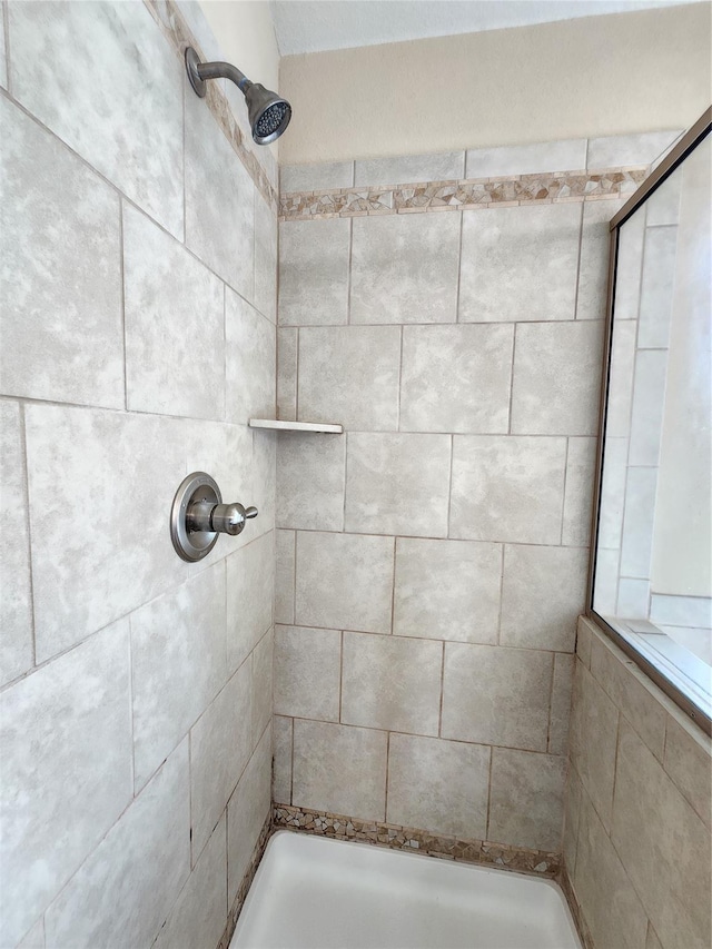 bathroom with tiled shower