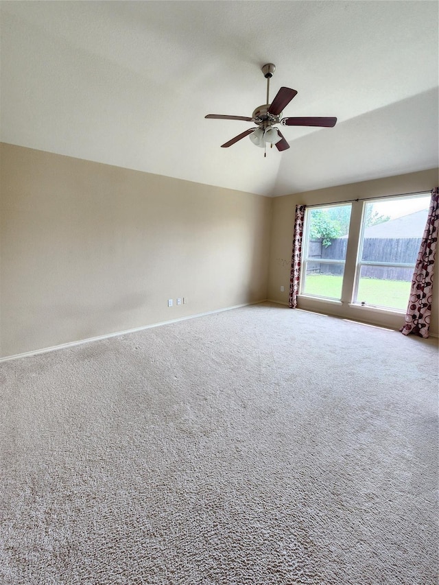 empty room with lofted ceiling, carpet flooring, and ceiling fan