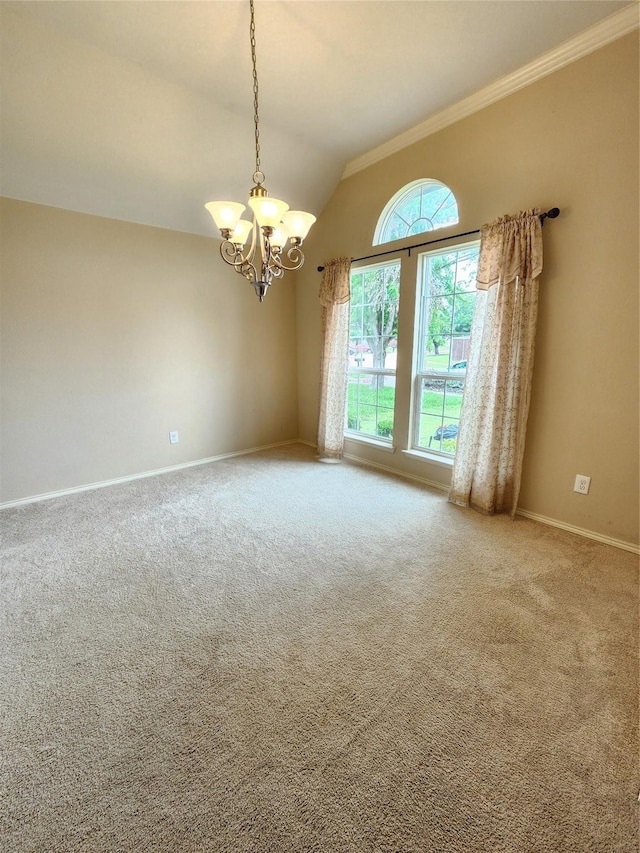 empty room with lofted ceiling, a notable chandelier, ornamental molding, and carpet