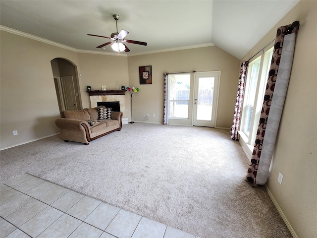 unfurnished living room with ceiling fan, light colored carpet, ornamental molding, and lofted ceiling