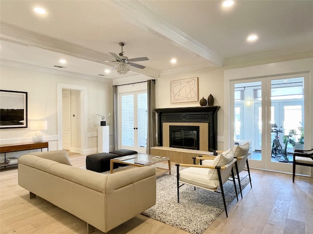 living room with crown molding, light hardwood / wood-style flooring, ceiling fan, and french doors