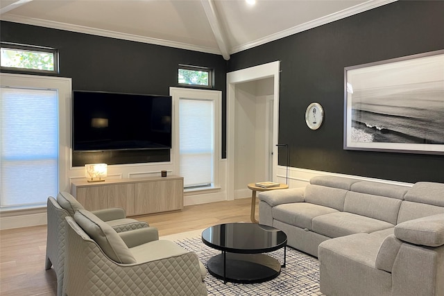 living room with vaulted ceiling with beams, light hardwood / wood-style flooring, and ornamental molding