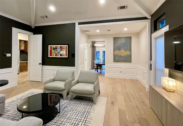 interior space with crown molding and light hardwood / wood-style floors