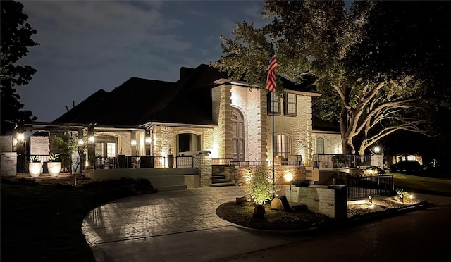 property exterior at night featuring a patio