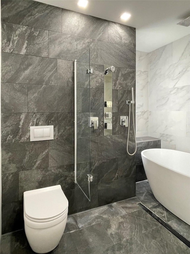 bathroom featuring toilet, separate shower and tub, and tile walls