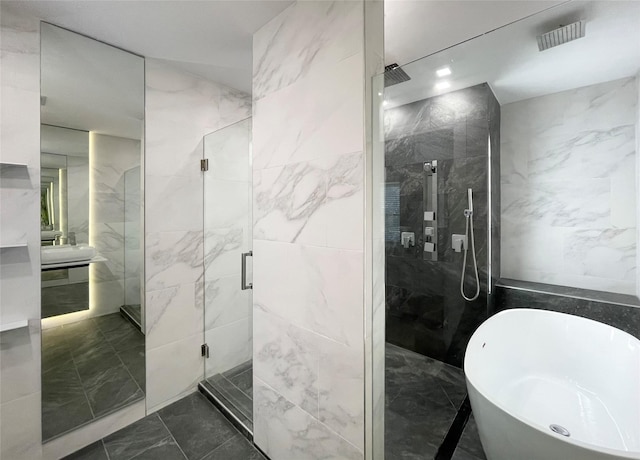 bathroom featuring shower with separate bathtub, tile walls, and vanity