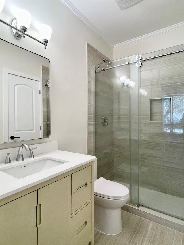 bathroom featuring vanity, an enclosed shower, ornamental molding, and toilet