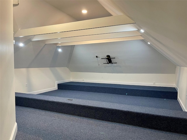 staircase featuring carpet floors and vaulted ceiling